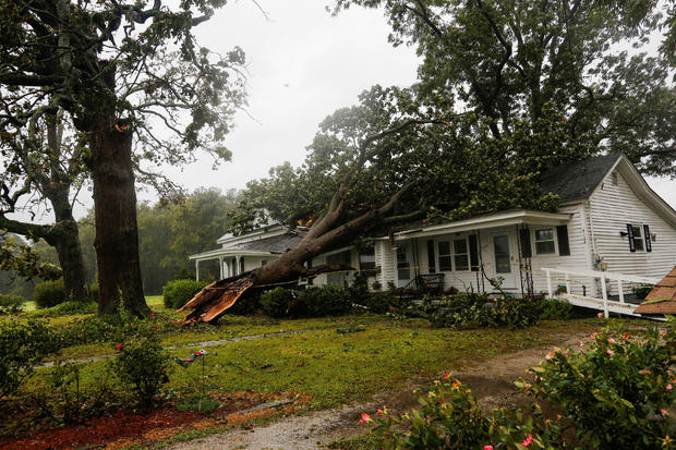 A downed tree rests on a house during the passing of Hurricane Florence in the town of Wilson 