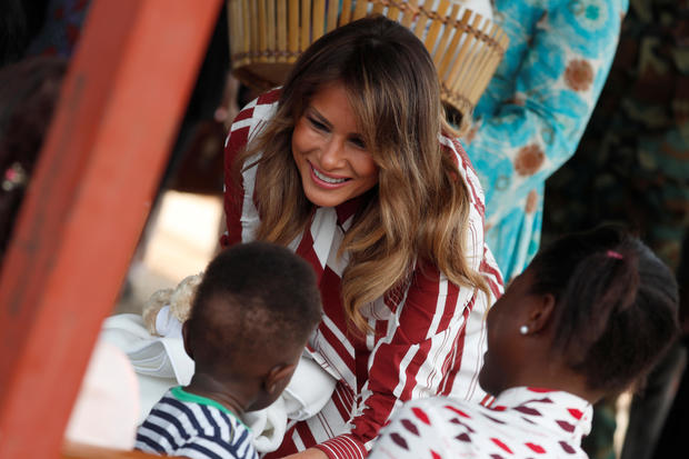 U.S. first lady Melania Trump greets a child during a visit to a hospital in Accra 