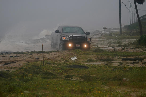 A truck drives along a road that has been washed out as Hurricane Michael comes ashore in Alligator Point 