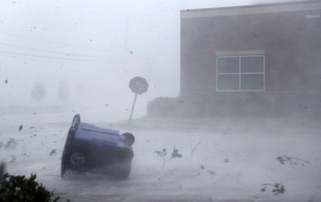 A trash can and debris are blown down a street by Hurricane Michael on Oct. 10, 2018, in Panama City, Florida. The hurricane made landfall on the Florida Panhandle as a Category 4 storm.
