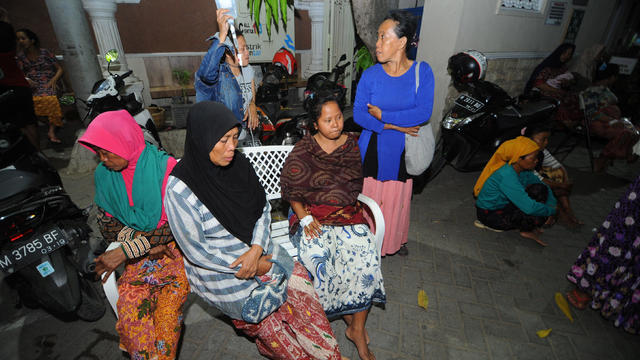 Patients sit at an open area after an earthquake, at Larasati hospital in Pamekasan 