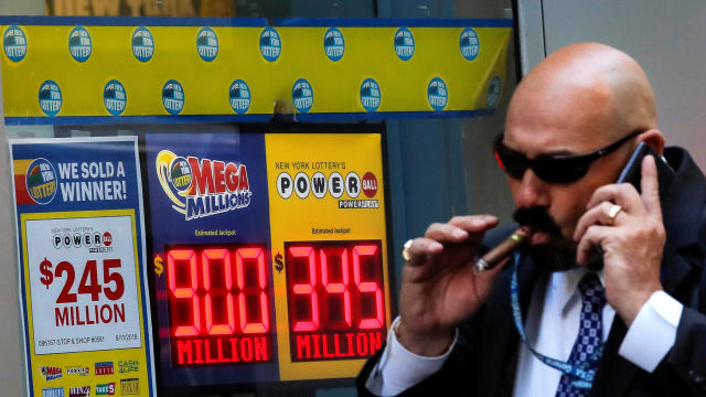 Signs display the jackpots for the Mega Millions and Powerball lottery drawings at the New York State Lottery office in New York City Oct. 17, 2018. 