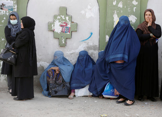 Afghan women line up to cast their votes during a parliamentary election at a polling station in Kabul 