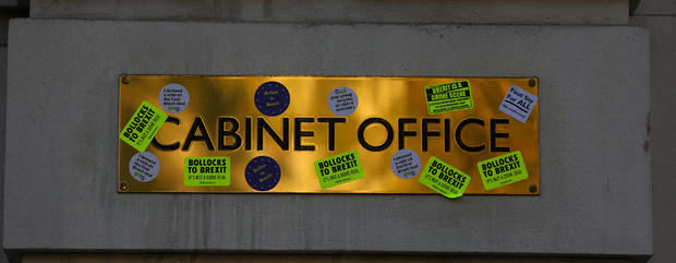Stickers are seen stuck onto the Cabinet Office name-plate during an anti-Brexit demonstration march through central London 