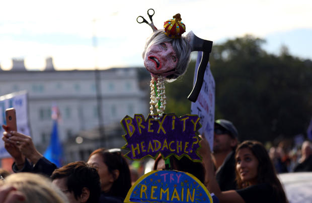 Protesters participating in an anti-Brexit demonstration, carry an effigy of Britain's Prime Minister Theresa May, as they march through central London 