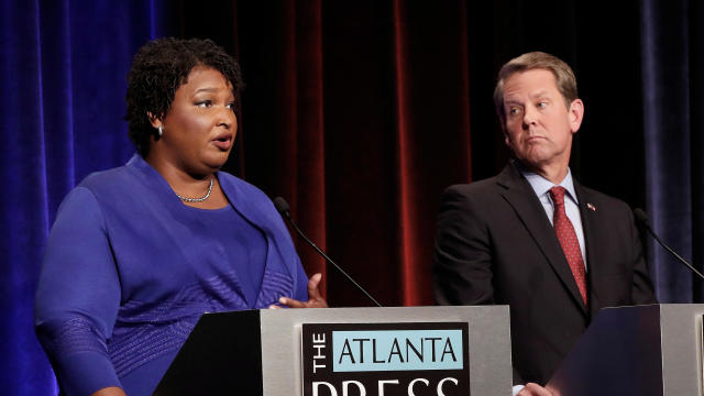 Democratic gubernatorial candidate for Georgia Stacey Abrams speaks as Republican candidate Brian Kemp looks on during a debate in Atlanta 