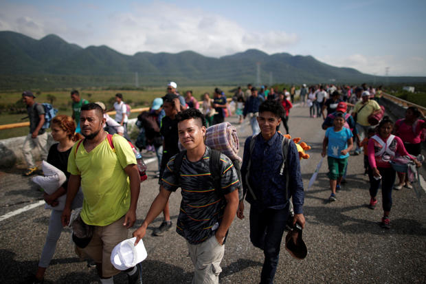 Migrants, traveling with a caravan of thousands from Central America en route to the United States, walk along the highway to Juchitan from Santiago Niltepec 