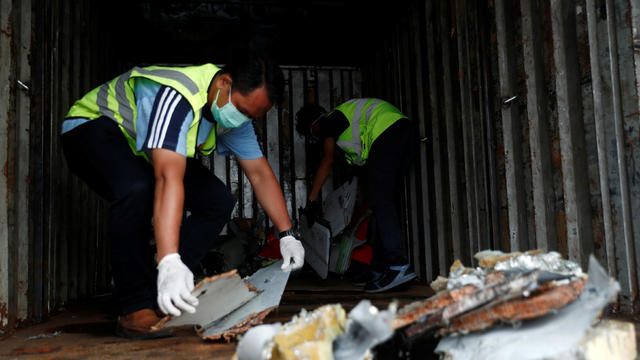 Workers load up recovered debris and belongings believed to be from Lion Air flight JT610 onto a truck at Tanjung Priok port in Jakarta 