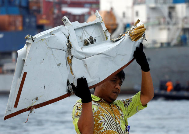 A worker loads up recovered debris believed to be from Lion Air flight JT610 onto a truck at Tanjung Priok port in Jakarta 