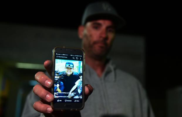 Jason Coffman displays a photo of his son Cody outside the Thousands Oaks Teen Center where he came hoping to find his son who was at the Borderline Bar and Grill in Thousand Oaks, California, on Nov. 8, 2018. 