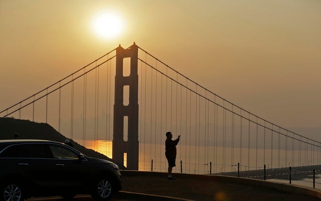 Mahmoud El Tahawy of Egypt looks out at smoke from wildfires obscuring the San Francisco skyline behind the Golden Gate Bridge Nov. 9, 2018, near Sausalito, California. 