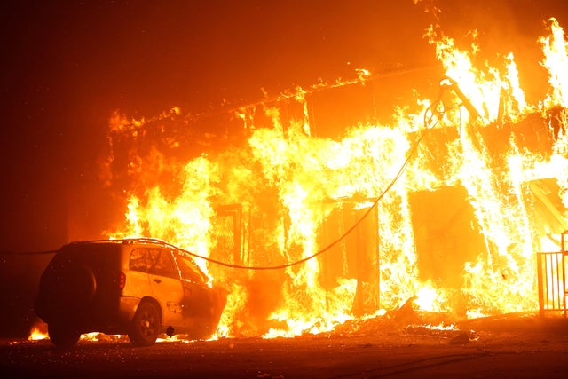 A structure is seen engulfed in flames during the so-called "Camp Fire" in Paradise, California, Nov. 8, 2018. 