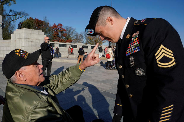 Vietnam war Army veteran Larry Dawson talks about the beret worn by Army Sergeant First Class Ryan Mata at World War II Memorial on Veterans Day in Washington 