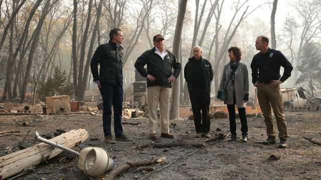 President Donald Trump visits the charred wreckage of Skyway Villa Mobile Home and RV Park with Governor-elect Gavin Newsom Brock Long Paradise Mayor Jody Jones and Governor Jerry Brown in Paradise California 