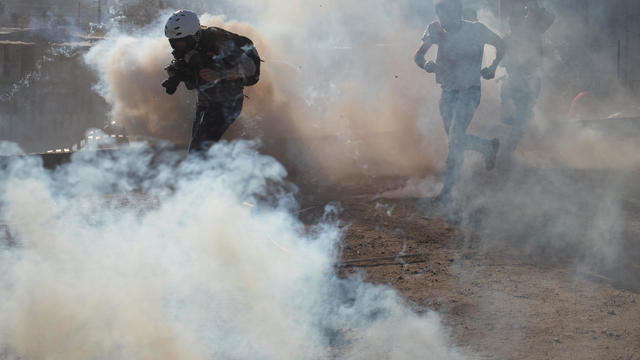 A photojournalist is surrounded in a cloud of tear gas released by U.S. Customs and Border Protection (CBP) after migrants, part of a caravan of thousands from Central America, attempted to illegally cross the border into the United States from Tijuana 