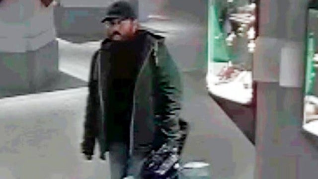 A CCTV image provided by police shows one of the three men who are suspected of stealing a Renoir painting from an auction house in Vienna, Austria, Nov. 26, 2018. 