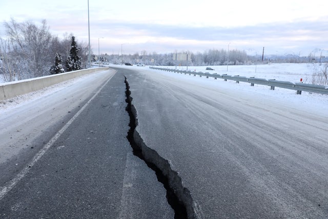 A crack which opened up along a roadway near the airport is seen after an earthquake in Anchorage