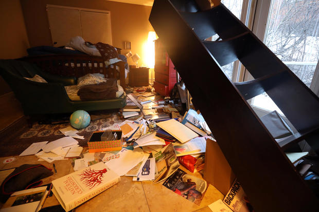 The contents of a bookshelf lie on the floor after an earthquake in Anchorage 