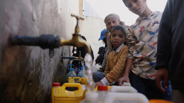 People collect drinking water from charity tap amid fears of a new cholera outbreak in Sanaa 