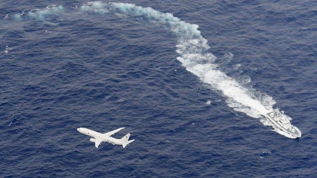 A Japan Coast Guard patrol vessel and U.S. Navy airplane conduct search and rescue operation at the area where two U.S. Marine Corps aircraft have been involved in a mishap in the skies, off the coast of Kochi prefecture 