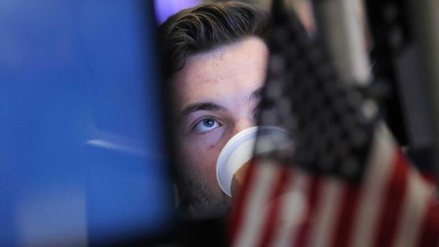 A trader works on the floor at the New York Stock Exchange (NYSE) in New York City 