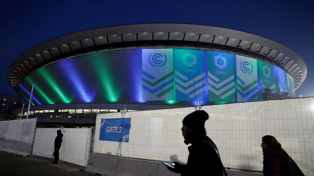 People walk in front of the venue of the COP24 U.N. Climate Change Conference 2018 in Katowice 