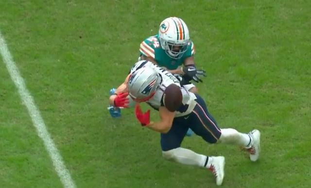 FILE - In this Sunday, Dec. 9, 2018 file photo, New England Patriots strong  safety Duron Harmon (21) tackles Miami Dolphins running back Frank Gore  (21), during the first half of an