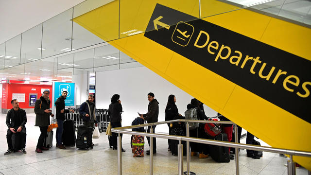 Passengers wait in the South Terminal building at Gatwick Airport, after the airport reopened to flights following its forced closure because of drone activity, in Gatwick 