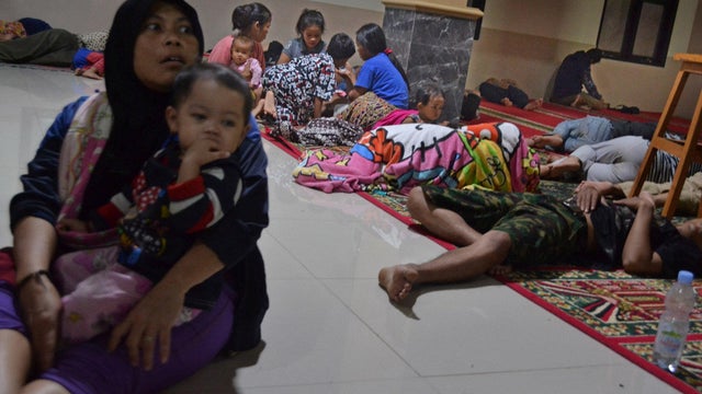 Residents sit inside a mosque as they evacuated following high waves and the eruption of Anak Krakatau volcano at Labuan district in Pandeglang regency 