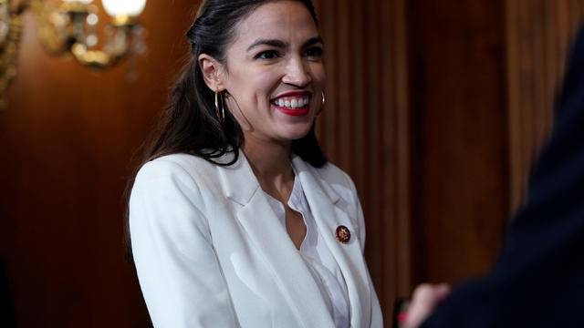 Rep. Alexandria Ocasio-Cortez (D-NY) waits for a ceremonial swearing-in picture on Capitol Hill in Washington 