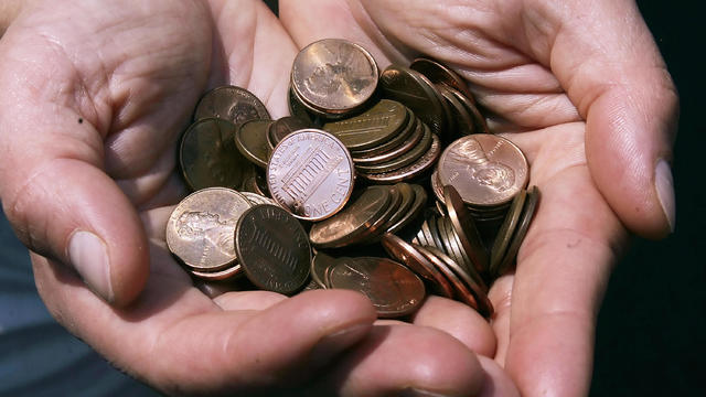 A man shows a handful of the US cent 18 