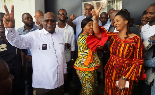 FILE PHOTO: Felix Tshisekedi, leader of the Congolese main opposition party, the Union for Democracy and Social Progress (UDPS), and a presidential candidate, shows a victory sign after casting his ballot at a polling station in Kinshasa 