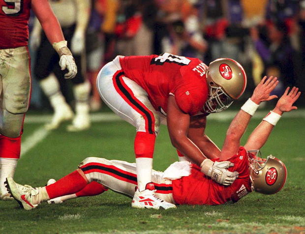 San Francisco 49ers quarterback Steve Young (on gr 