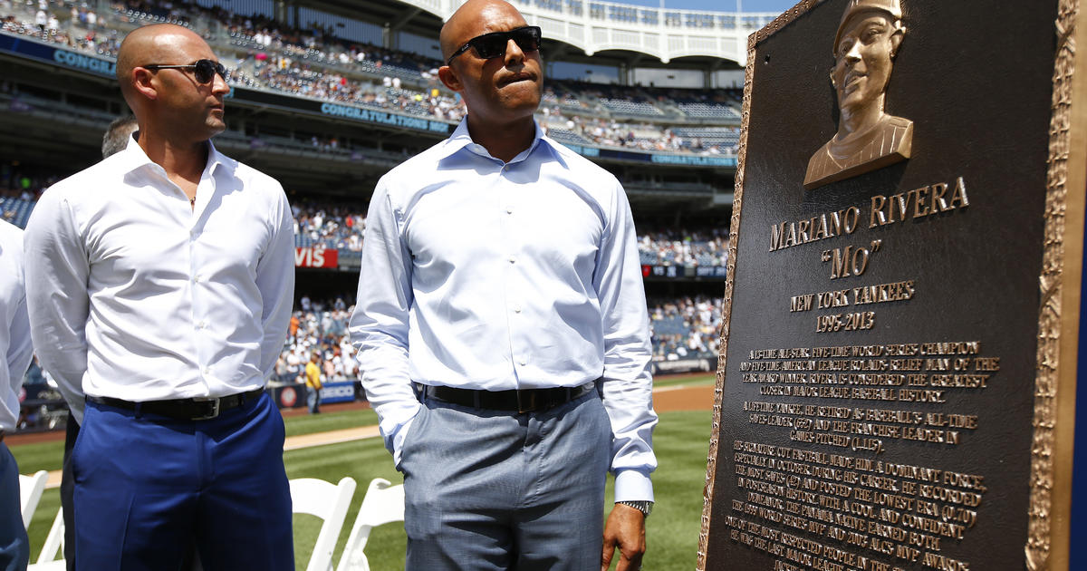 New York Yankees relief pitcher Mariano Rivera (42) poses with a plaque  showing his retired number in Monument Park during a pregame ceremony at  Yankees Stadium before a baseball game against the