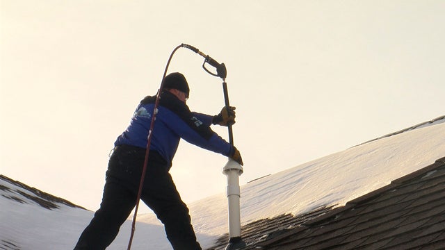man-defrosts-furnace-gas-exhaust.jpg 