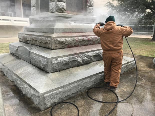 cleaning off vandalized Confederate monument in Dallas 