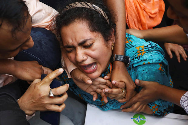 One of the relatives of victims of a fire incident mourns outside Dhaka Medical College Hospital in Dhaka, Bangladesh 