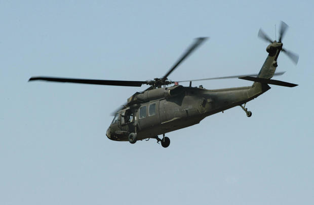 A US Army Black Hawk helicopter flies ov 