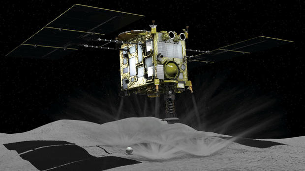 A computer graphic handout image shows Japan Aerospace Exploration Agency's Hayabusa 2 probe touches down on an asteroid in outer space 