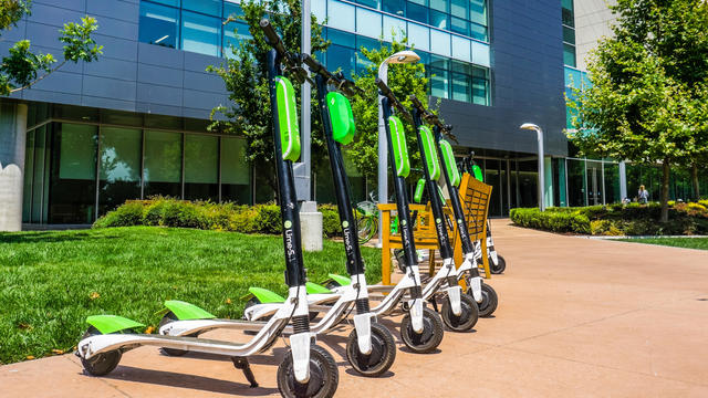 Lime Scooters lined up at a LimeHub 