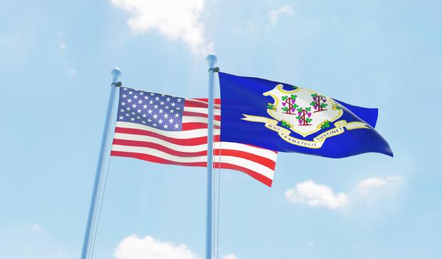 USA and state Connecticut, two flags waving against blue sky 