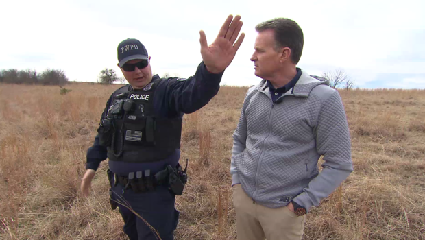 Fort Worth Officer Matt Pearce talks to Doug Dunbar in the spot where Pearce was shot six times. 