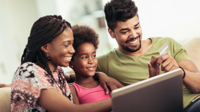 family shops online using a laptop 