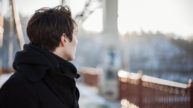 Young man standing on the bridge 