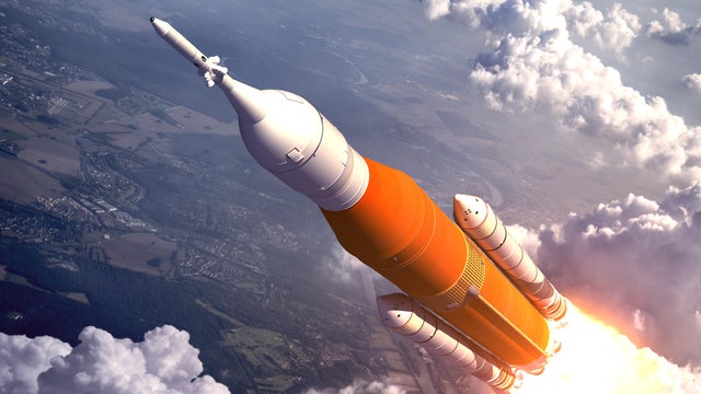 American Space Launch System Flying Over The Clouds 