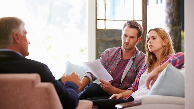 Couple At Home Meeting With Financial Advisor 