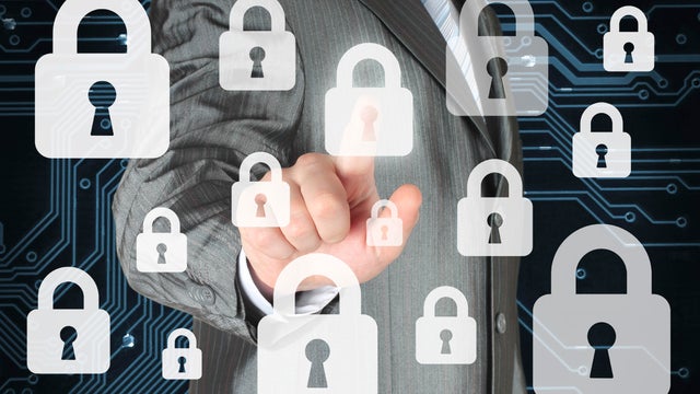 Businessman pushing virtual security button 