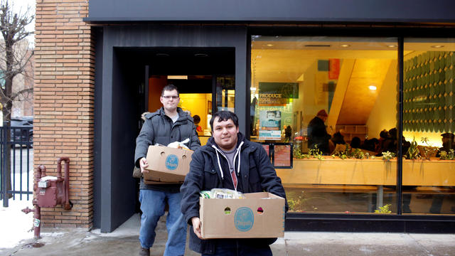 TSA worker Salinas and his fiancee Farmer leave the Lakeview Pantry after receiving food in Chicago 