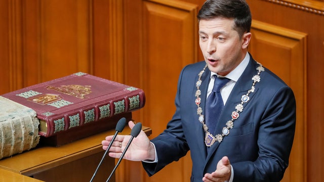 Ukraine's new President Volodymyr Zelenskiy applauds after taking the oath of office during his inauguration ceremony in the parliament hall in Kiev 