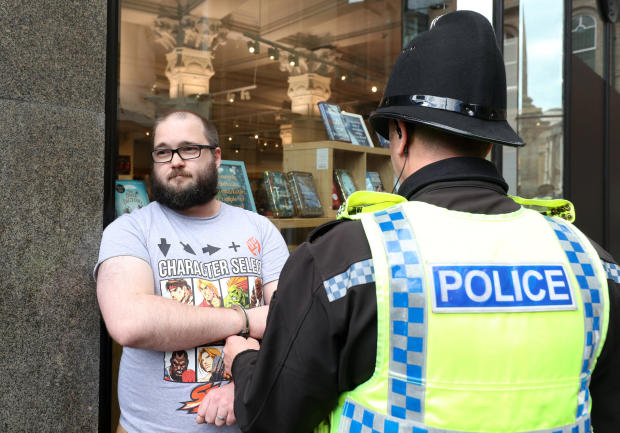 A man is detained by police after throwing a milkshake on Brexit Party leader Nigel Farage before a Brexit Party campaign event in Newcastle, Britain, May 20, 2019. 